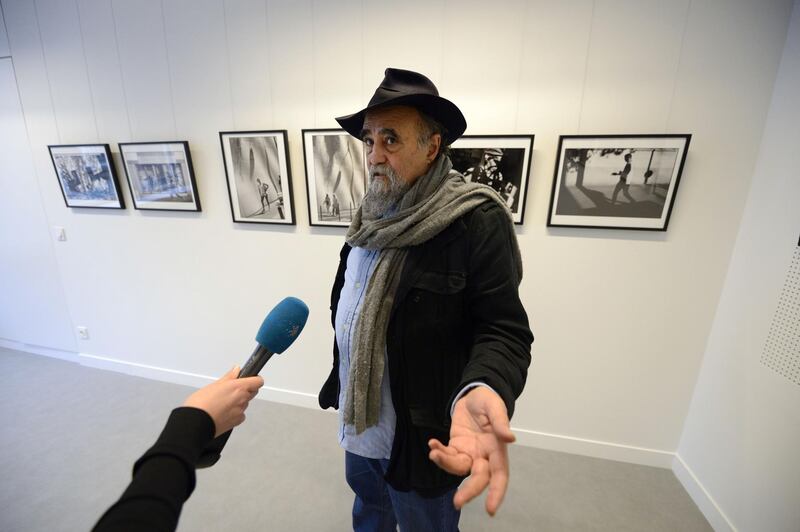(FILES) In this file photo taken on November 28, 2013 in Paris, Magnum photographer Abbas answers journalists' questions in front of some of his pictures, displayed at the Islamic Institute of Culture on its inauguration day.
Abbas, Iranian photojournalist and Magnum photographer, died at the age of 74 in Paris.   / AFP PHOTO / Eric Feferberg