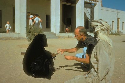 Dr Pat Kennedy treating a woman at the original hospital compound, circa 1961. This handout photograph is an archival image of the Oasis hospital Al Ain in the 1960s. Courtesy of Brooks Glett/Oasis Hospital