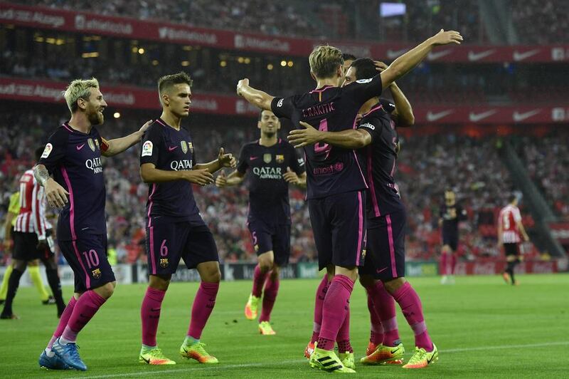 Barcelona’s Ivan Rakitic, second right, celebrates with Arda Turan after scoring. Alvaro Barrientos / AP Photo