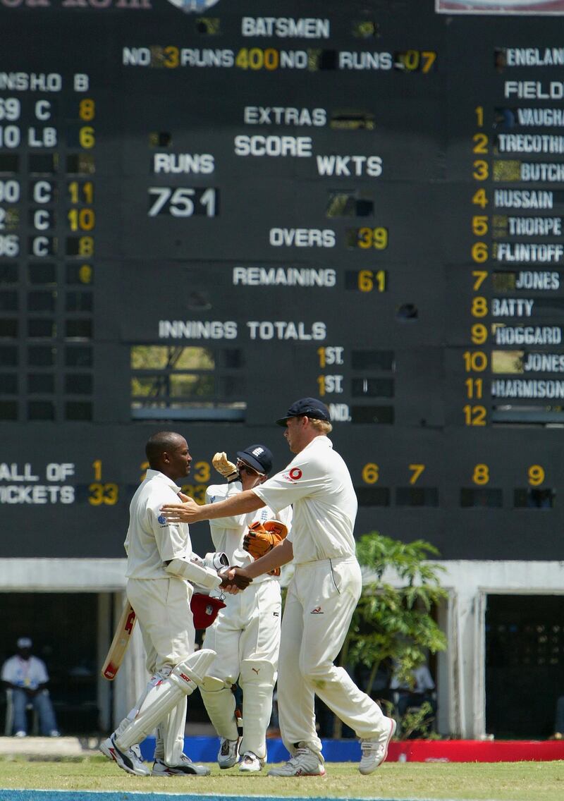 ST JOHNS, ANTIGUA - APRIL 12:  Brian Lara is congratulated by Andrew Flintoff after achieving 400 runs during day three of the fourth Test match between the West Indies and England at the Recreation Ground on April 12, 2004 in St Johns, Antigua. (Photo by Clive Rose/Getty Images).