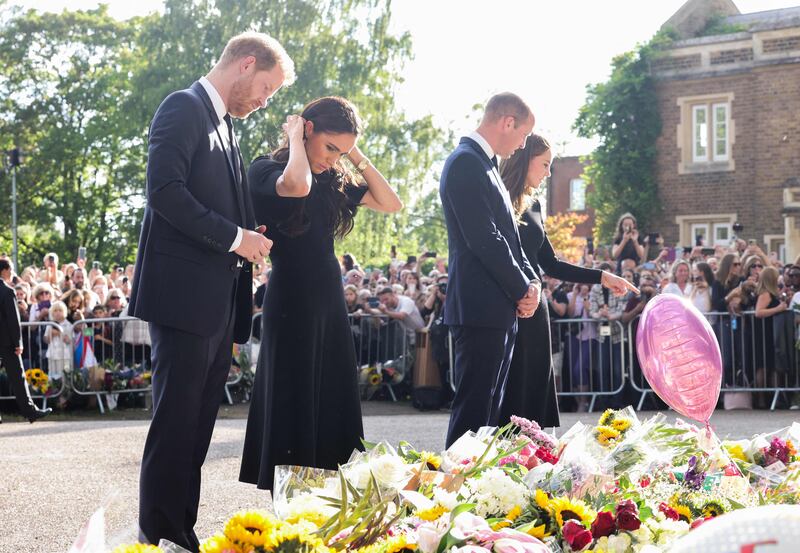 A pause to look at floral tributes laid by members of the public on the Long Walk at Windsor Castle. AFP