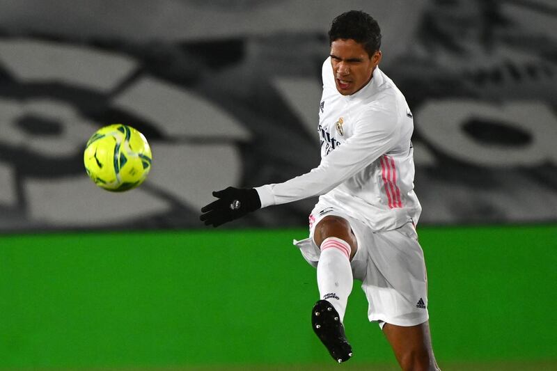 (FILES) In this file photo taken on February 09, 2021 Real Madrid's French defender Raphael Varane kicks the ball during the Spanish league football match between Real Madrid CF and Getafe CF at the Alfredo di Stefano stadium in Valdebebas, on the outskirts of Madrid on February 9, 2021. Real Madrid's French defender Raphael Varane tested positive for Covid-19 on April 06, 2021. / AFP / GABRIEL BOUYS
