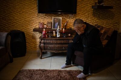 LEBANON: Monday 13 December 2021 Kayan Tleiss cries in front of the shrine dedicated to his brother in his living room in Khalde, in the southern suburbs of Beirut. Oliver Marsden for The National 