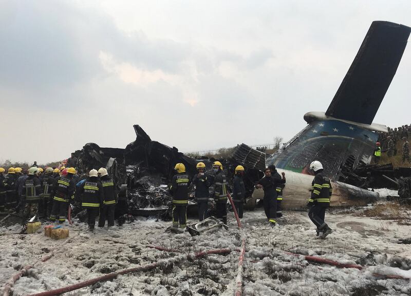 Wreckage of an airplane is pictured as rescue workers operate at Kathmandu airport, Nepal. Navesh Chitrakar / Reuters