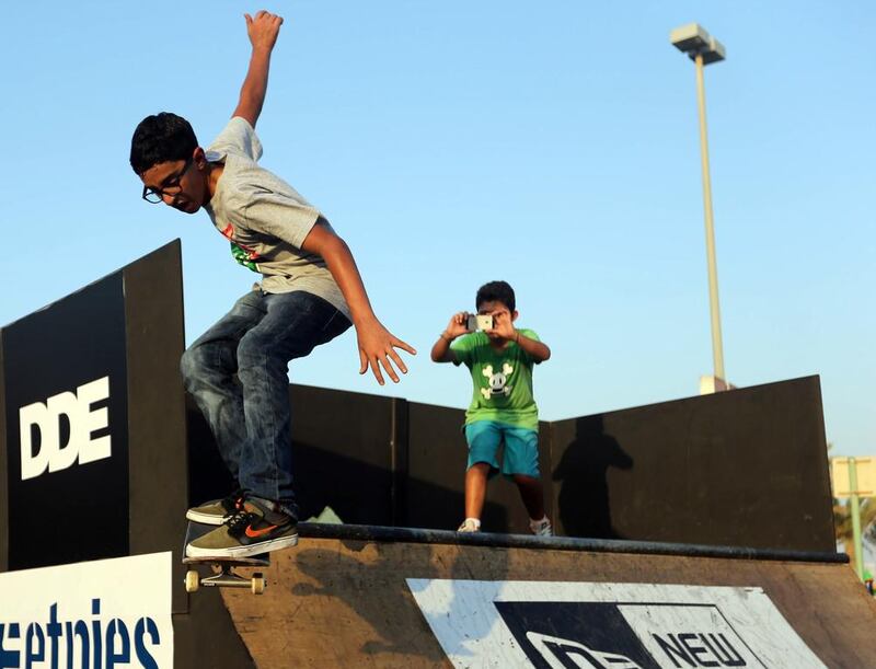 Diab Fahim, 13, uses a ramp set up at the Abu Dhabi International Show to perform a few tricks while his friend Jason Iliovits, 13, films the trick in Abu Dhabi. Sammy Dallal / The National