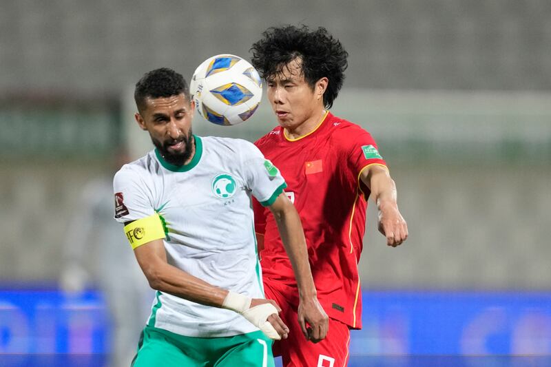 China's Junmin Hao and Saudi Arabia's Salman Alfaraj battle. AP