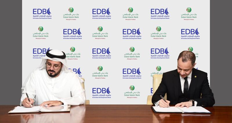 EDB chief executive Ahmed Al Naqbi and DIB group chief executive Adnan Chilwan sign the preliminary agreement. Photo: EDB and DIB