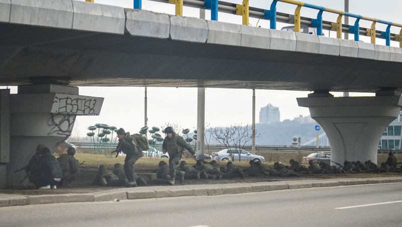 Ukrainian soldiers take up defensive positions under a bridge. AP Photo