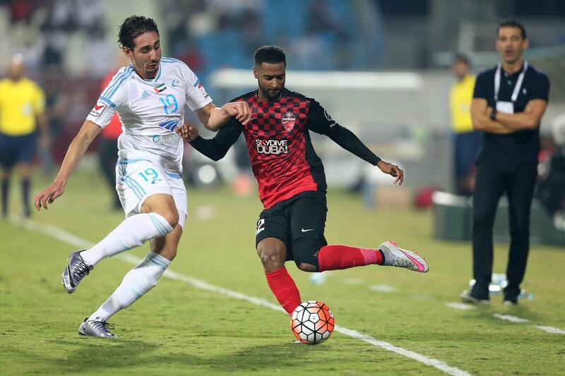 Abdulaziz Sanqour of Al Alhli, right, holds off Ishak Belfodil of Baniyas during the Arabian Gulf League match. Mostafa Reda / Al Ittihad