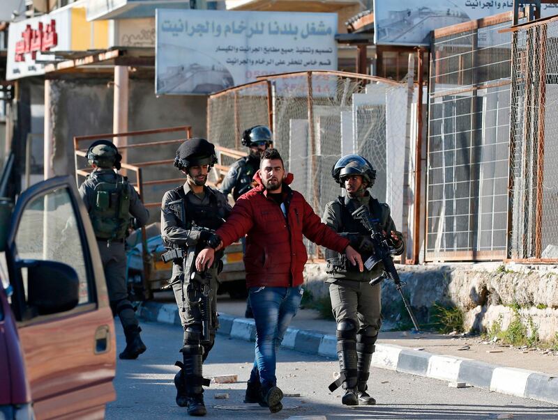 Israeli soldiers detain a Palestinian man during clashes between Palestinian demonstrators and Israeli troops in Ramallah. AFP