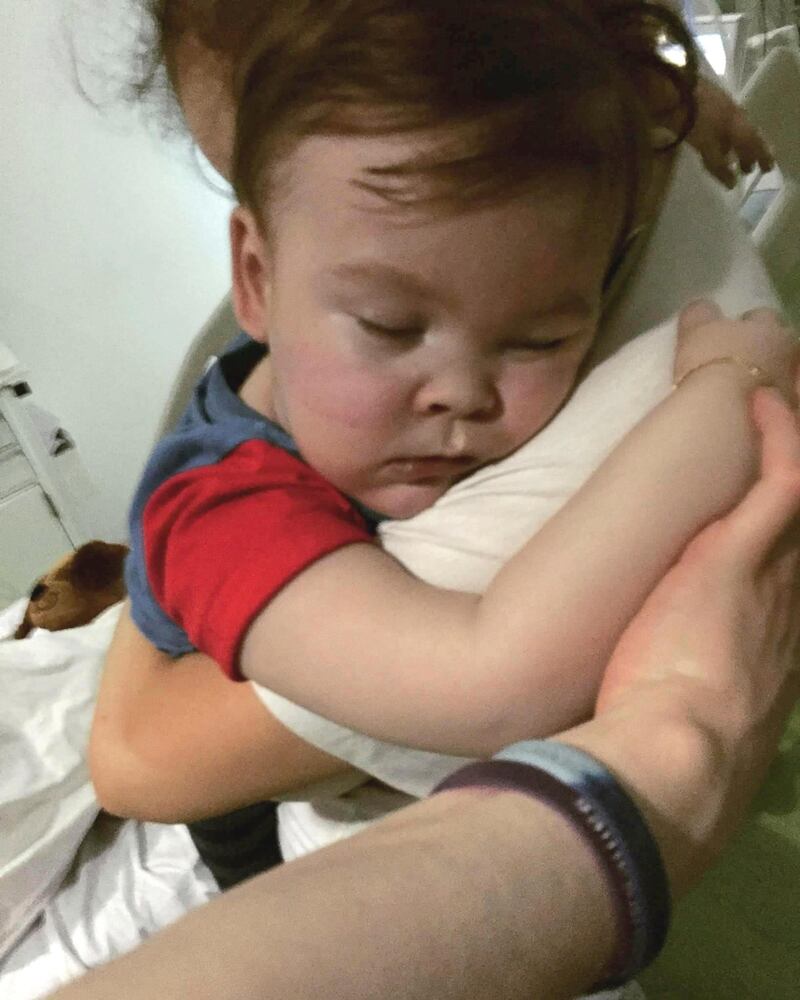 In this April 23, 2018 handout photo provided by Alfies Army Official, brain-damaged toddler Alfie Evans cuddles his mother Kate James at Alder Hey Hospital, Liverpool, England. Kate James and Tom Evans, the parents, said on Facebook that 23-month-old Alfie Evans, who had an incurable degenerative brain condition and was at the center of a legal battle over his treatment, died early morning Saturday April 28, 2018. (Alfies Army Official via AP)
