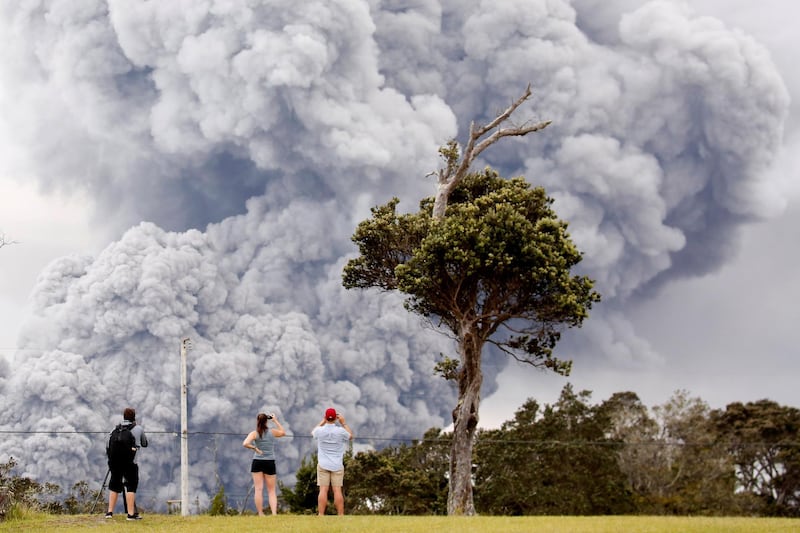 People watch as ash erupts from the Halemaumau crater near the Kilauea Volcano in Hawaii, US. Terray Sylvester / Reuters