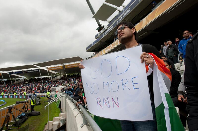 An India fan displays a sign against the rain, during the team's ICC Champions Trophy Final cricket match against England at Edgbaston cricket ground, Birmingham, England, Sunday June 23, 2013. (AP Photo/Jon Super) *** Local Caption ***  Britain ICC Trophy Final England India Cricket.JPEG-08c2e.jpg