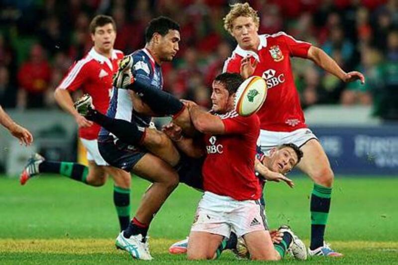Rory Sidey of the Rebels is tackled by the Lions' Brad Barritt, centre, in Melbourne, Australia. David Rogers / Getty Images