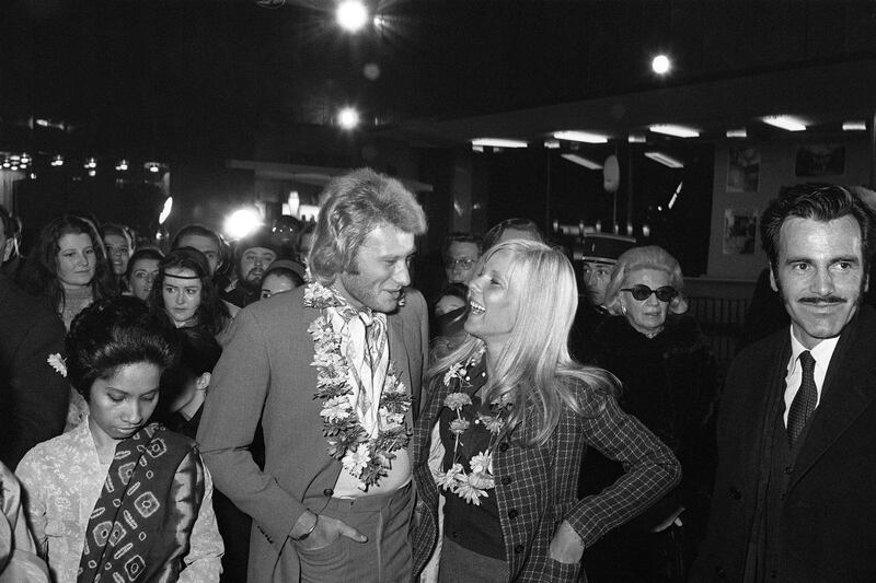 (FILES) In this file photo taken on February 1, 1969 French singer Johnny Hallyday (L) and then his wife singer Sylvie Vartan attend the preview of the film "Krakatoa, a l'est de Java" directed by Bernard Kowalski (not pictured) with Austrian actor Maximilian Schell (R) at a Parisian cinema.
France's best-known rock star Johnny Hallyday has died aged 74 after a battle with lung cancer, his wife Laeticia told AFP on December 6, 2017. / AFP PHOTO / -