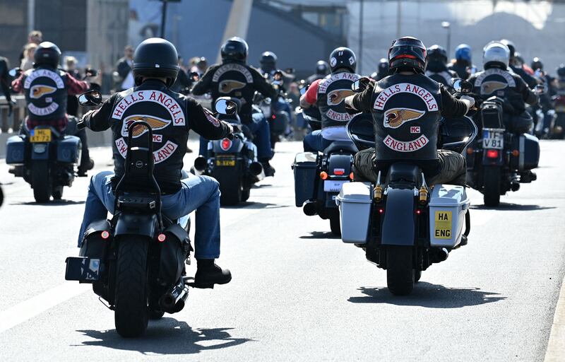 Members ride across London Bridge in March 2022. AFP