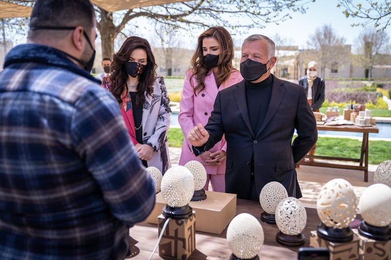 King Abdullah II, accompanied by Queen Rania Al Abdullah, views sample products from beneficiaries of the Productive Youth Initiative. Courtesy Royal Hashemite Court