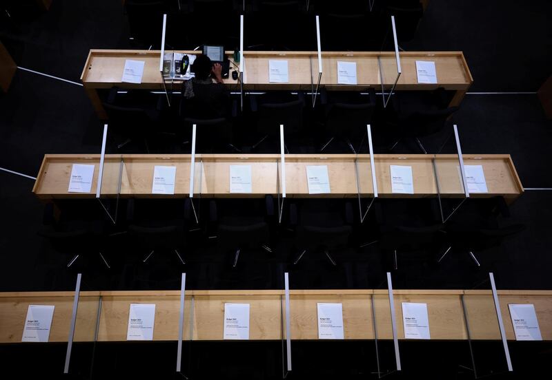 A member of parliament sits between plexiglass shields in Vienna, Austria. Reuters