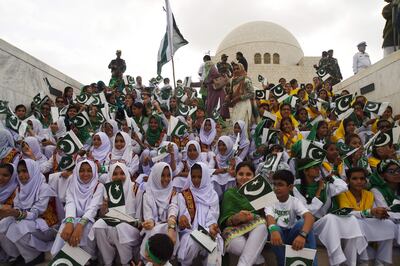 Pakistani students hold national flags during a ceremony at the mausoleum of Pakistan's founder Mohammad Ali Jinnah to mark the country's Independence Day in Karachi on August 14, 2017.
This month marks 70 years since British India split into two nations -- Hindu-majority India and Muslim-majority Pakistan -- and millions were uprooted in one of the largest mass migrations in history. Pakistan celebrates its independence on August 14, one day before India's independence day on August 15.

 / AFP PHOTO / ASIF HASSAN