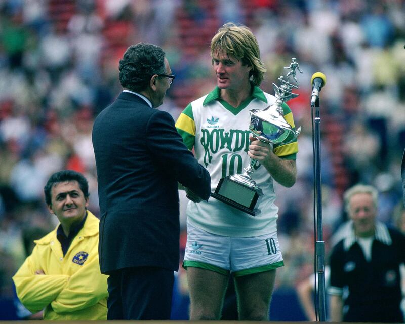 Football - North American Soccer League - 1979  
Rodney Marsh - Tampa Bay Rowdies receives the trophy from Henry Kissinger 
Mandatory Credit: Action Images / Sporting Pictures  / Reuters
CONTRACT CLIENTS PLEASE NOTE: ADDITIONAL FEES MAY APPLY - PLEASE CONTACT YOUR ACCOUNT MANAGER