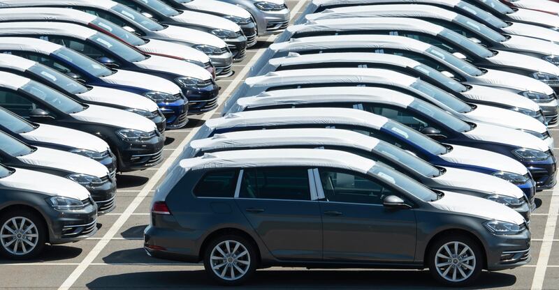 Volkswagen cars stand at a parking area during the production restart of the plant of the German manufacturer Volkswagen AG (VW) in Zwickau, Germany, Thursday, April 23, 2020. Volkswagen starts with step-by-step resumption of production. The car company are completely converting the plant in Zwickau from 100 percent combustion engine to 100 percent electric. (AP Photo/Jens Meyer)