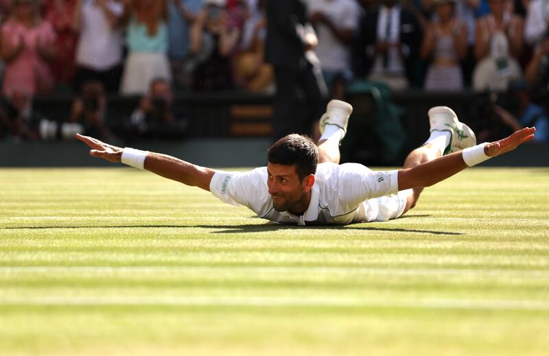 Novak Djokovic celebrates after winning match point at the All England Club. Getty