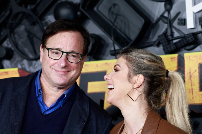 Saget, left, and wife Kelly Rizzo attend the 'MacGruber' screening and premiere at the California Science Center on December 8, 2021 in Los Angeles. AFP