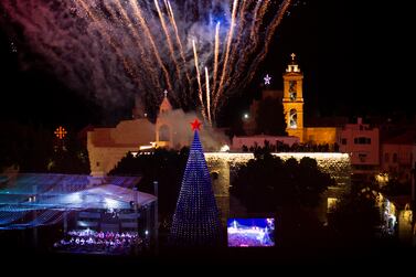 Fireworks burst over the Church of the Nativity in Manger Square in the West Bank town of Bethlehem during the lighting of the Christmas tree, Saturday, Dec.  4, 2021.  It was the fist time since the coronavirus that the square was full for the lighting of the Christmas tree, but local vendors were hoping for a return of tourism.  (AP Photo / Maya Alleruzzo)