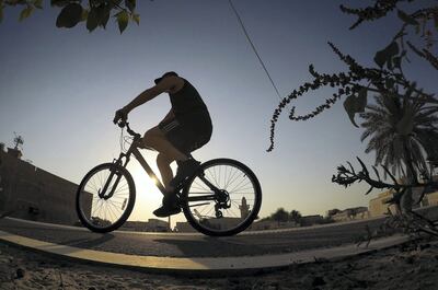 DUBAI, UNITED ARAB EMIRATES , May 22– 2020 :- One of the person riding bicycle on the cycle track alongside of Jumeirah beach road in Dubai. (Pawan Singh / The National) For News/Online.