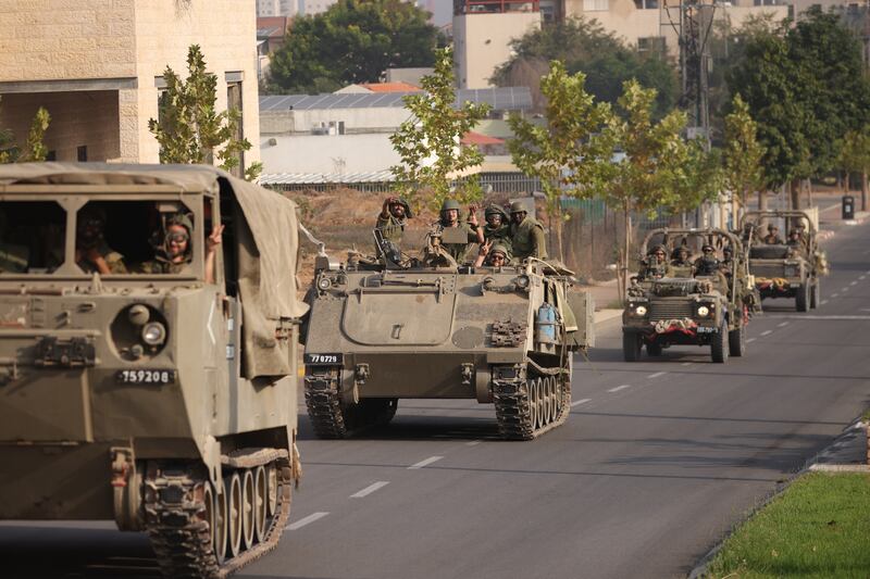 Israeli tanks and troops move through Sderot, near the border with Gaza, on Saturday. Getty Images