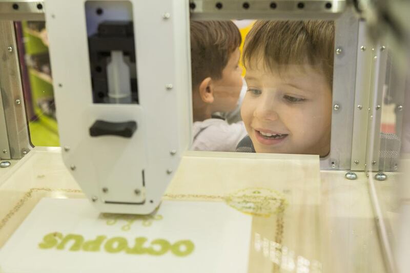 Children check out the Magic Candy Factory 3-D printer at Candylicious in Dubai Mall.  (Antonie Robertson / The National)


