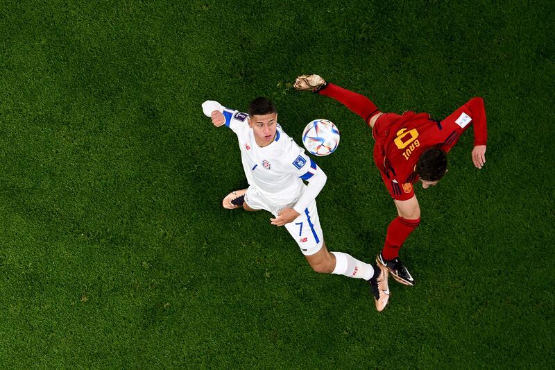 Anthony Contreras (L) keeps his eye on the ball as he fights for it with Spain midfielder Gavi. AFP
