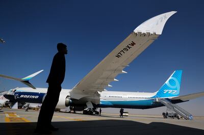 A visitor looks at the new Boeing 777-X on the second day of the Dubai airshow 2021. Chris Whiteoak/ The National