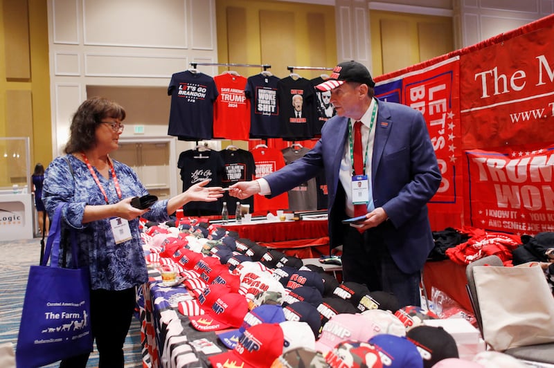 Maga Mall president Ronald Solomon sells merchandise at  CPAC. Reuters