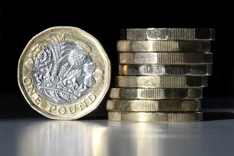 (FILES) In this file photo taken on October 05, 2017 British one pound sterling coins are arranged for a photograph in central London. Sterling sank Tuesday close to a one-month dollar low as investors fretted over heightened Brexit tensions before crunch trade talks between London and Brussels. In midday deals, the pound dropped more than 1.0 percent versus the greenback to hit $1.3022 -- a level last seen on August 12. / AFP / Daniel SORABJI
