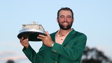 Scottie Scheffler with the Masters trophy and green jacket after his four-shot victory at Augusta National. Getty Images