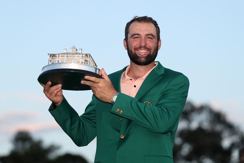 Scottie Scheffler with the Masters trophy and green jacket after his four-shot victory at Augusta National. Getty Images