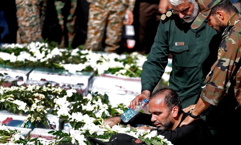 Father of four-year-old victim Mohammad Taha Eghdami, mourns over his body during a public funeral ceremony for those killed during an attack on a military parade on the weekend, in the southwestern Iranian city of Ahvaz on September 24, 2018. Four militants attacked a Saturday parade marking the start of the 1980-1988 Iran-Iraq war, spraying the crowd with gunfire and killing 24 people. / AFP / ATTA KENARE
