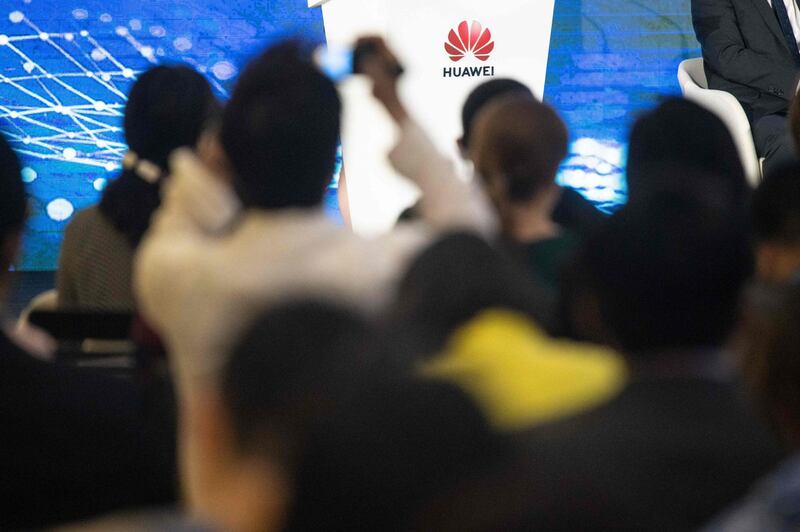 journalists and guests attend the Huawei database and storage product launch during a press conference at the Huawei Beijing Executive Briefing Centre in  Beijing.  AFP