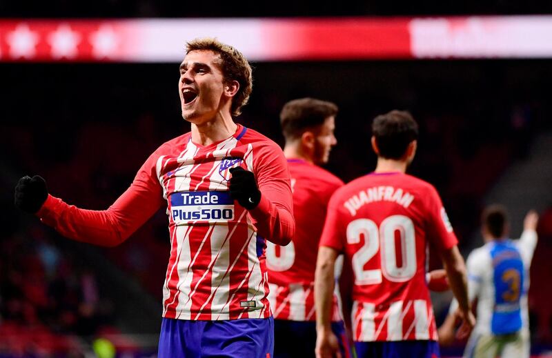 TOPSHOT - Atletico Madrid's French forward Antoine Griezmann celebrates his third goal during the Spanish league football match Club Atletico de Madrid against Club Deportivo Leganes SAD at the Wanda Metropolitano stadium in Madrid on February 28, 2018. / AFP PHOTO / PIERRE-PHILIPPE MARCOU