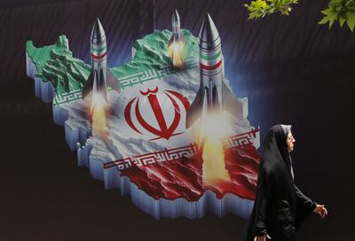 An anti-Israel banner displays pictures of Iranian missiles in Tehran. EPA 