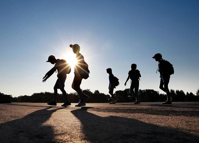 Pupils go for a walk shortly after sunrise in the outskirts of Frankfurt, Germany. Michael Probst / AP Photo