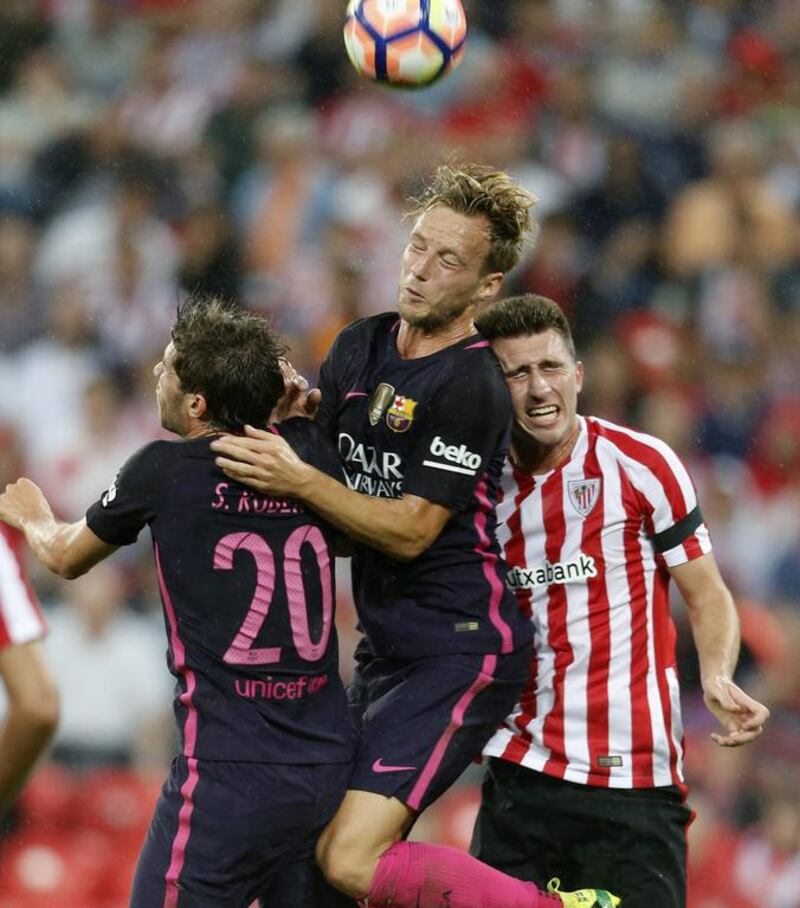 Athletic Bilbao’s French defender Aymeric Laporte, right, fights for the ball with defender Sergi Roberto. Luis Tejido / EPA