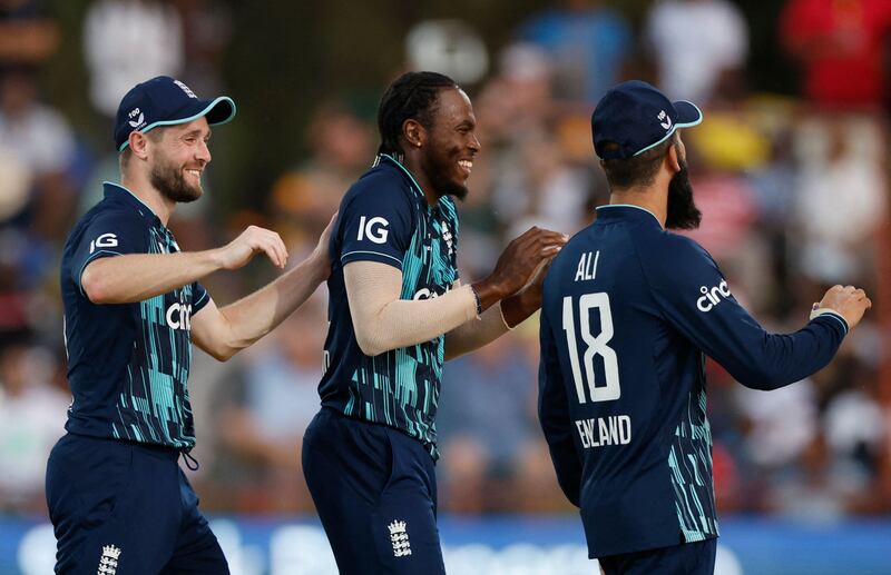 Jofra Archer, Chris Woakes and Moeen Ali celebrate after Ali took a catch to dismiss Aiden Markram off Archer's bowling. AFP