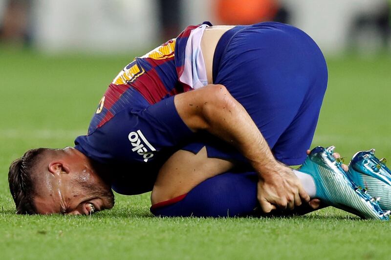 Barcelona's Carles Perez on the floor after a tackle from a Valencia player. EPA