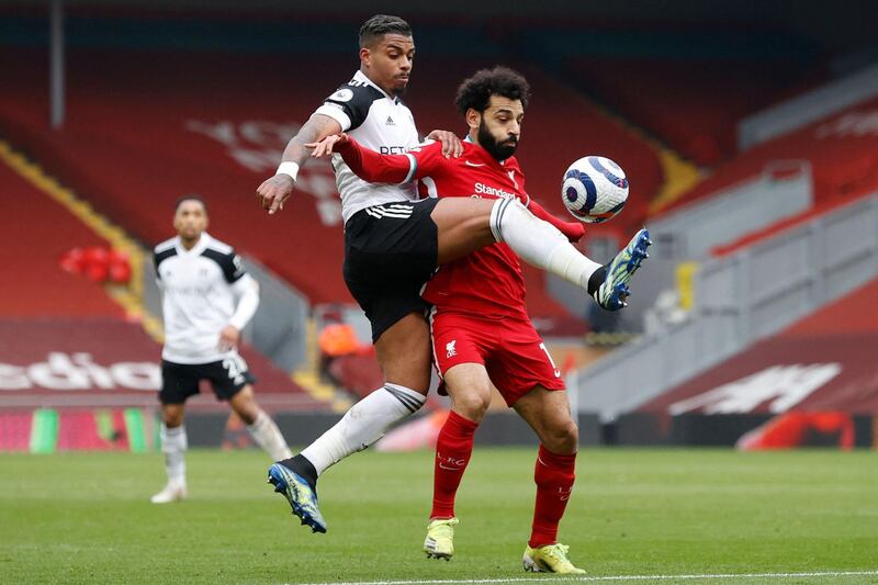 Fulham's Mario Lemina challenges Liverpool attacker Mohamed Salah. AFP