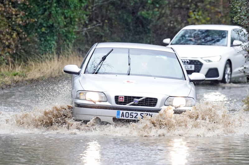Cars driving through floodwater near Whitley Bay, north-east England. PA
