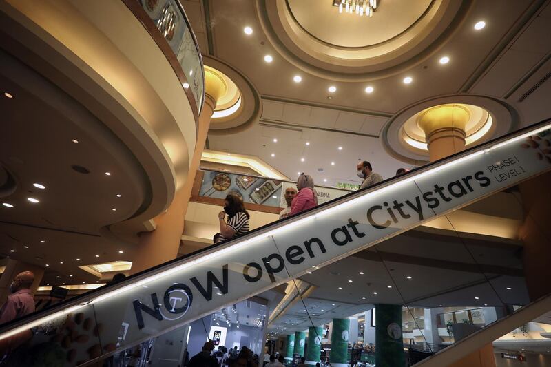 Shoppers take an escalator at a commercial mall in Cairo, Egypt. American credit rating agency Fitch Ratings Inc. expected GDP growth in Egypt at 2.5 per cent in the current fiscal year, down from the 5.6 per cent recorded in the last fiscal year. EPA