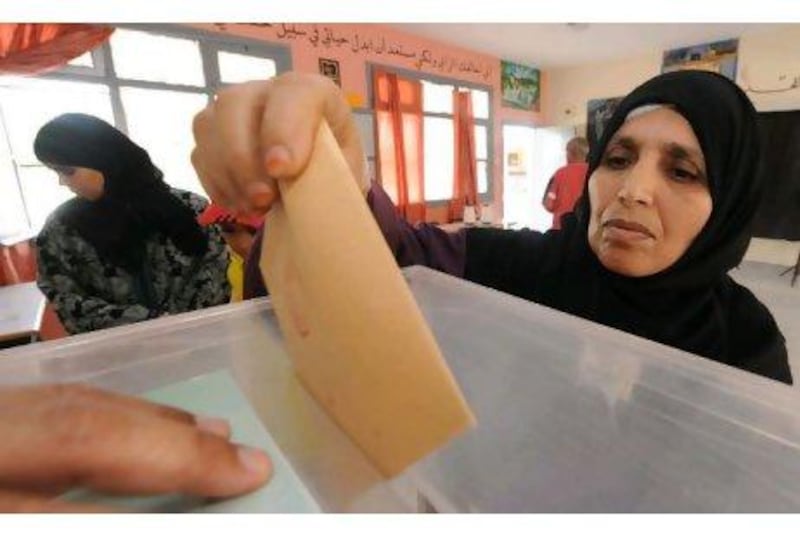 Moroccans post their ballots at a voting station in Sale on Friday.