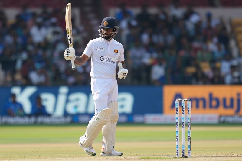 Sri Lanka's Dimuth Karunaratne celebrates reaching fifty. AP